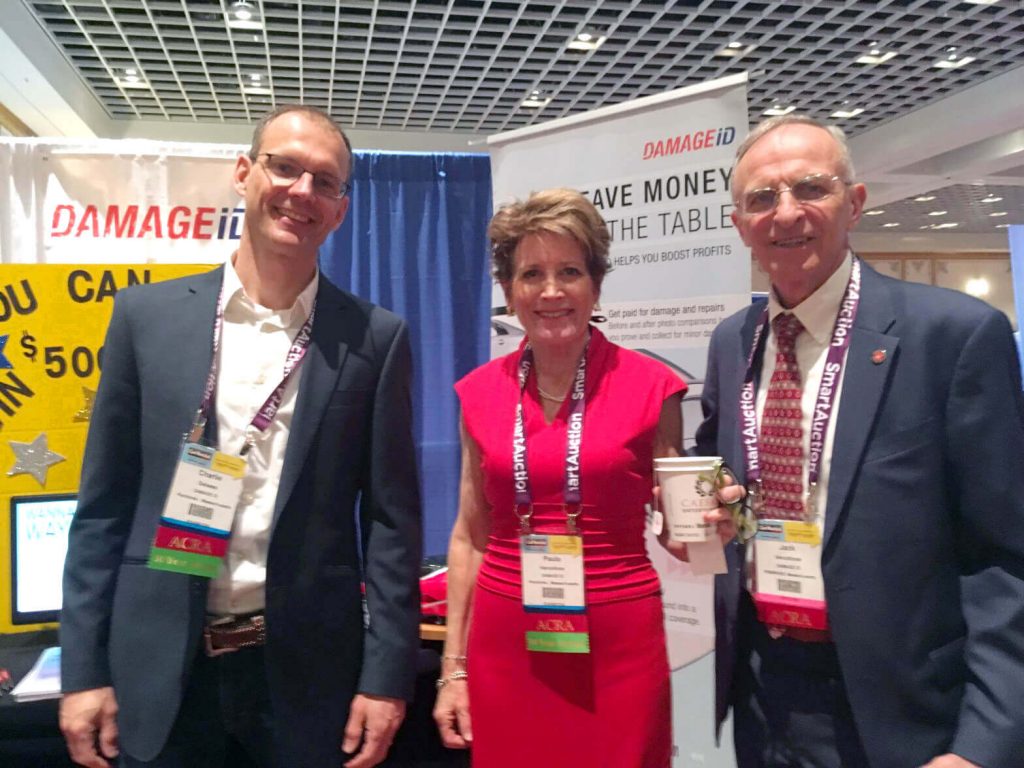 Carlie Dalsass and Paula and Jack Vercollone at the DAMAGEiD booth at the Paris Hotel in Las Vegas.