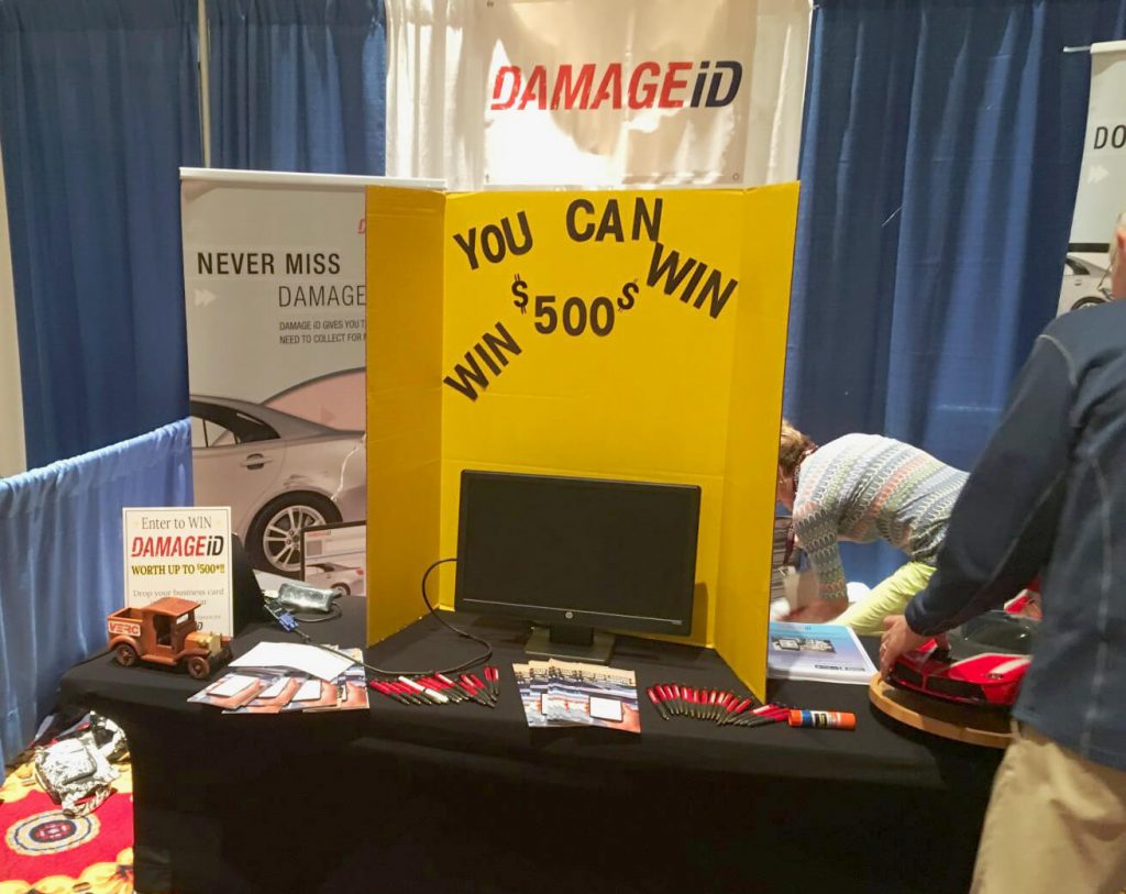 Setting up the DAMAGEiD presenter's booth at the 2019 International Car Rental Show.